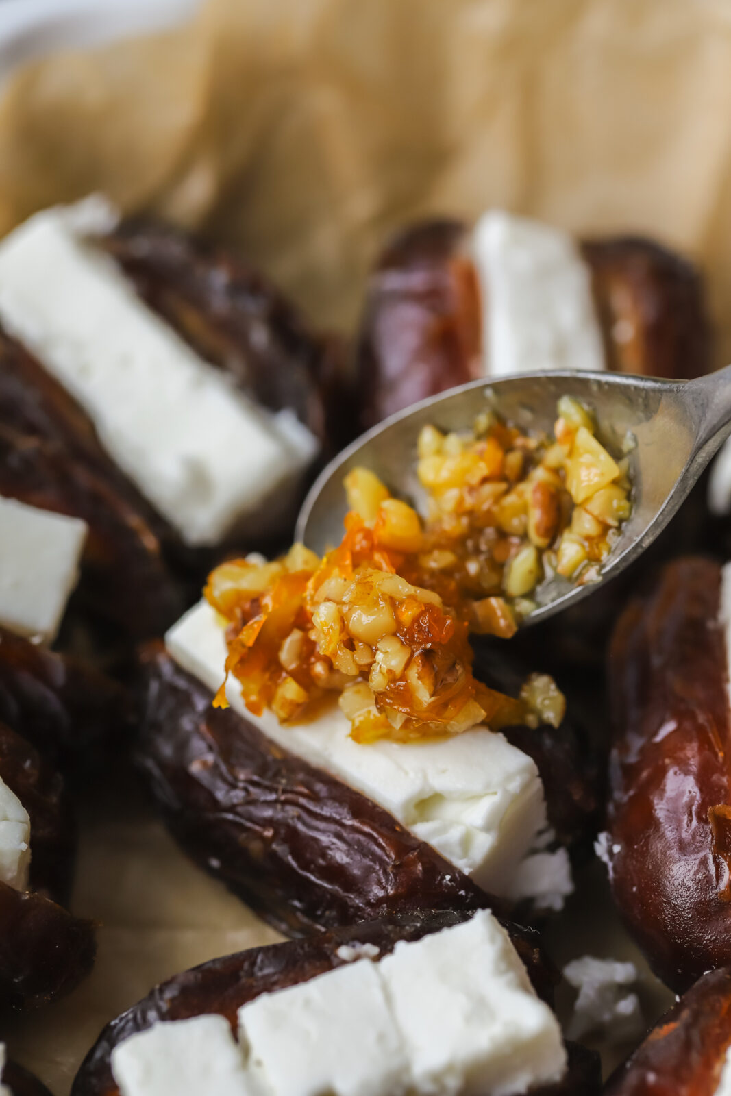 spooning topping on a stuffed date