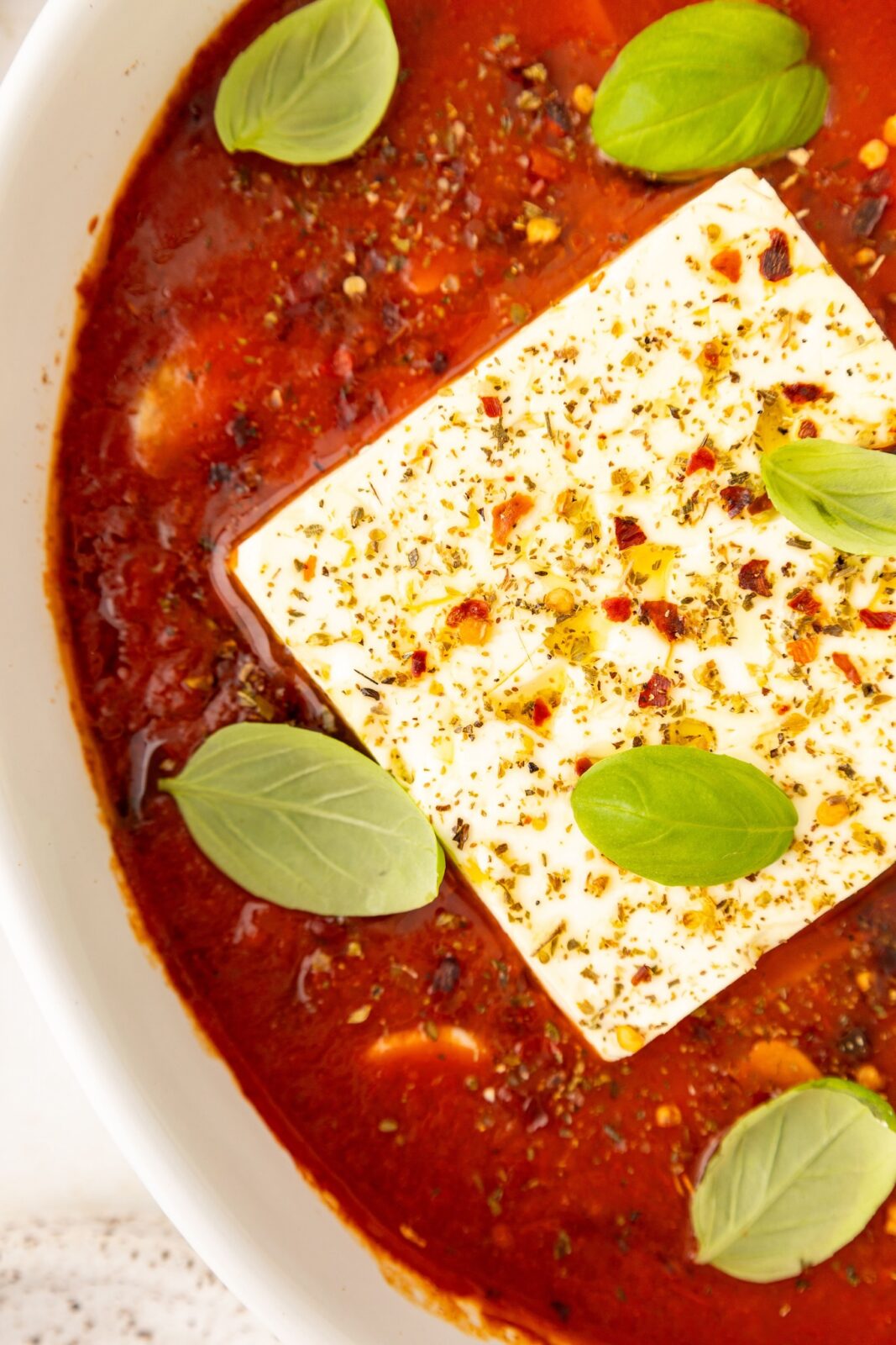 close up of baked feta in a baking dish