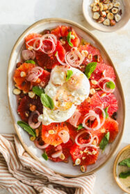 overhead of burrata ball on top of blood orange salad