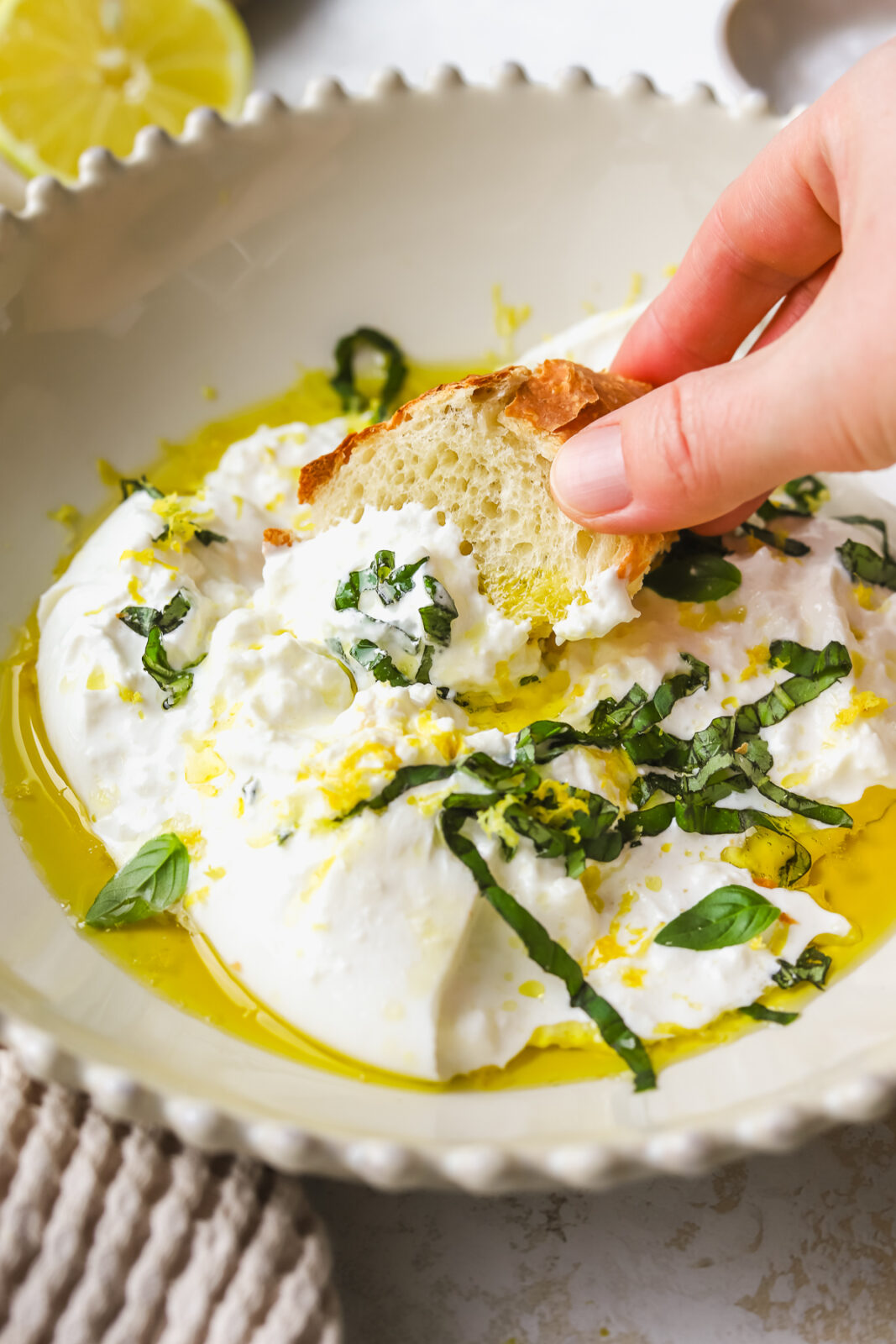 bread dipping into burrata